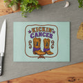 Mint tempered glass cutting board with cowboy boots and Kickin' Cancer design on a kitchen counter