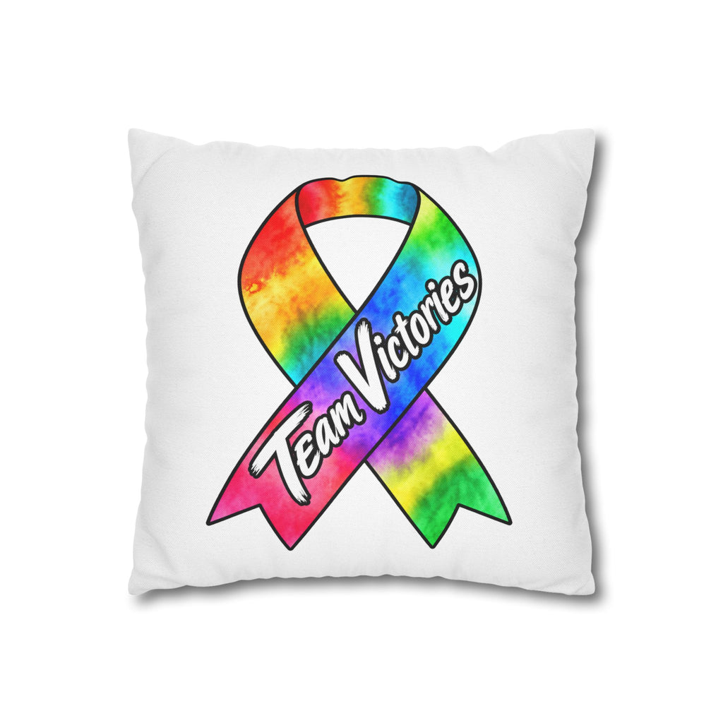 Team Victories all-cancer awareness ribbon pillow displayed on a couch