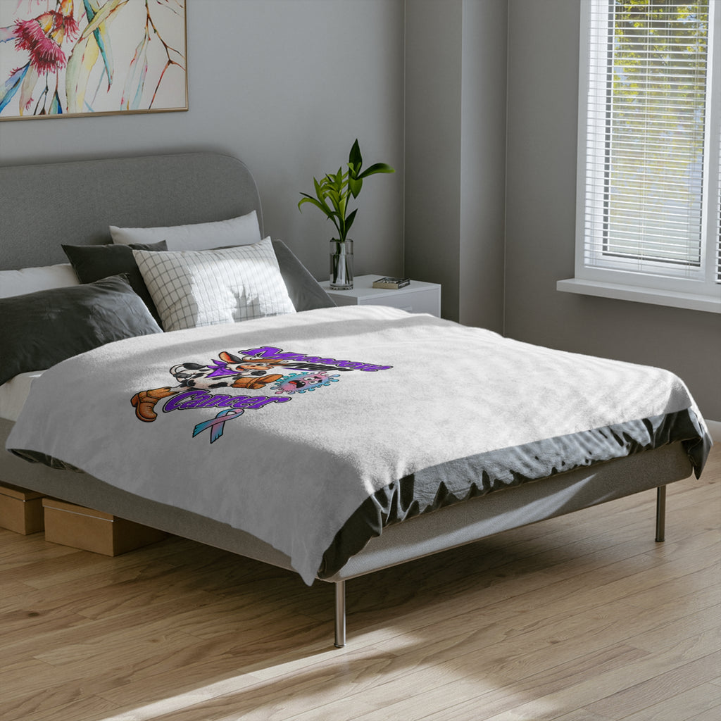 White Moooove Over Cancer blanket covering a bed with colorful artwork