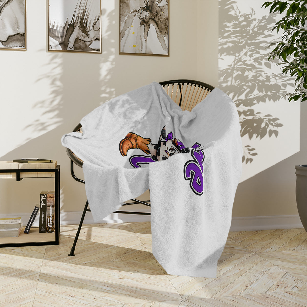 Moooove Over Cancer blanket shown draped over a chair