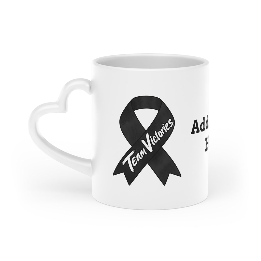 Moooove Over Cancer mug showing Team Victories cancer-awareness ribbon and heart-shaped handle