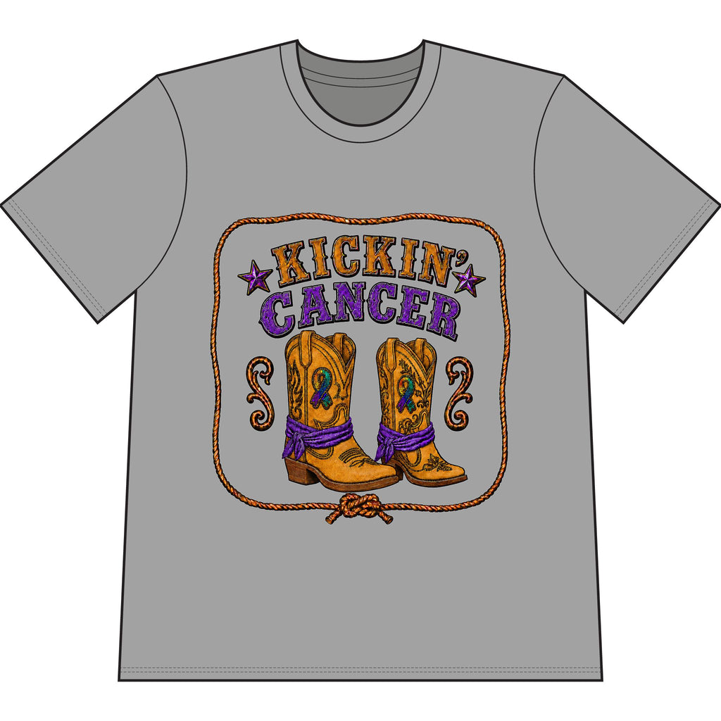 Kickin’ Cancer Cement heavyweight garment-dyed T-shirt with western boot and awareness-ribbon artwork.