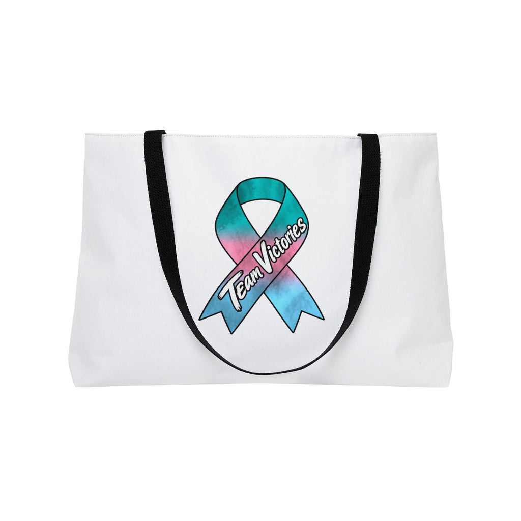 Reverse side of Team Victories weekender tote with a colorful awareness ribbon