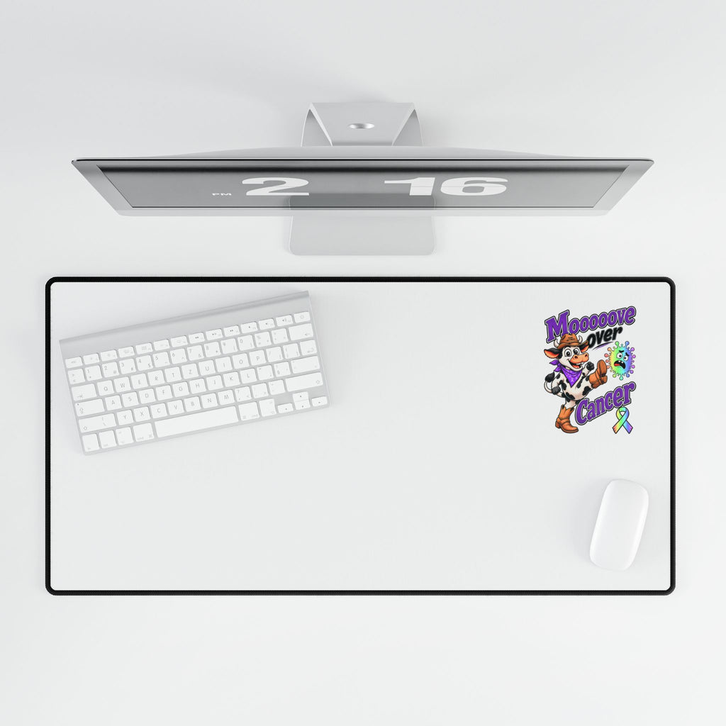 Top view of Moooove Over Cancer desk mat with keyboard, mouse, and all-cancer awareness ribbon