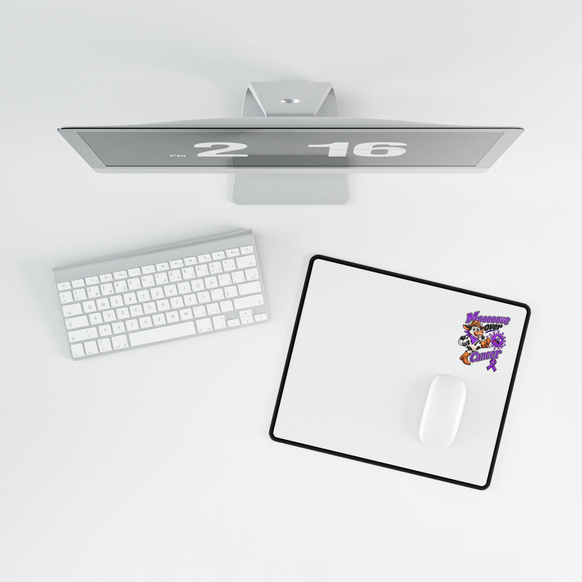 Moooove Over Cancer desk mat beneath a keyboard and monitor on a desktop