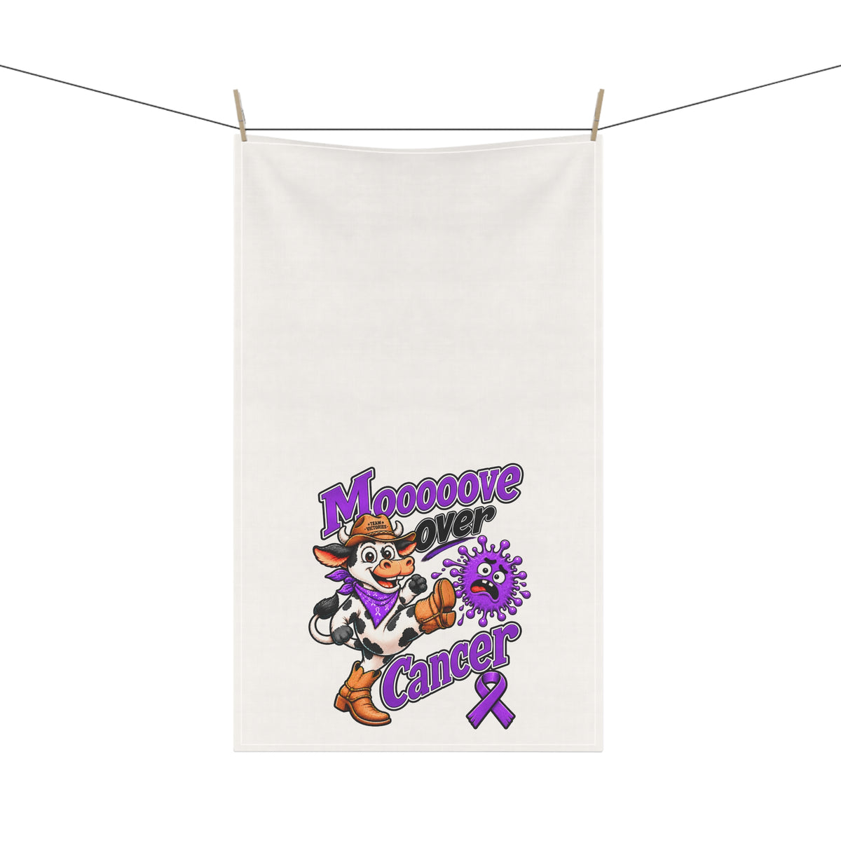 Moooove Over Cancer tea towel hanging outdoors with colorful cow and purple ribbon design