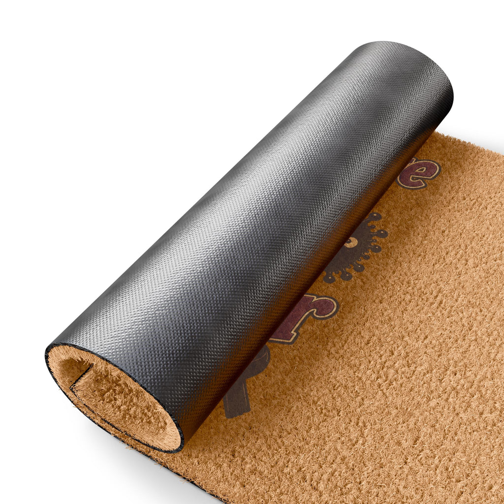 Rolled Moooove Over Cancer coir doormat showing the black vinyl backing