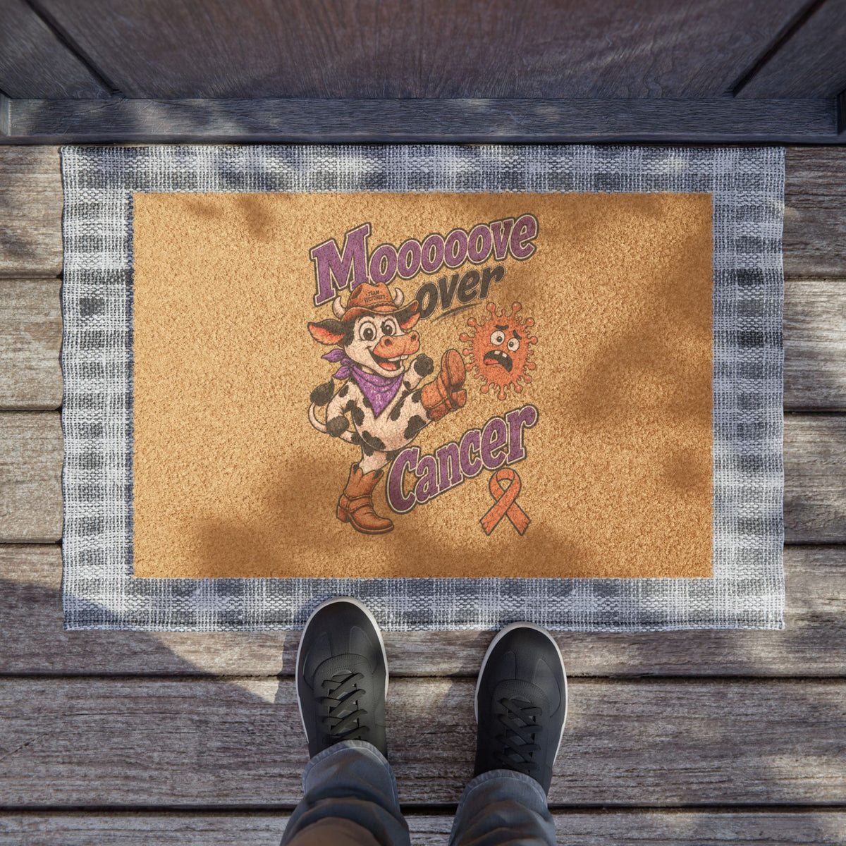 Moooove Over Cancer doormat at an entryway showing the full artwork and ribbon