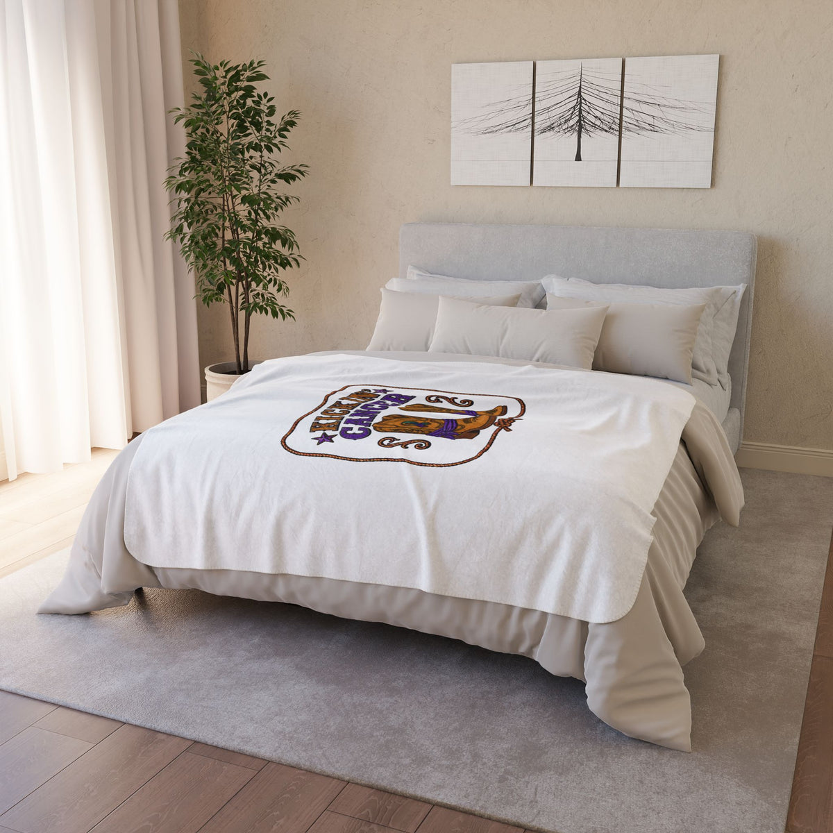 Kickin' Cancer sherpa blanket displayed across a neatly made bed