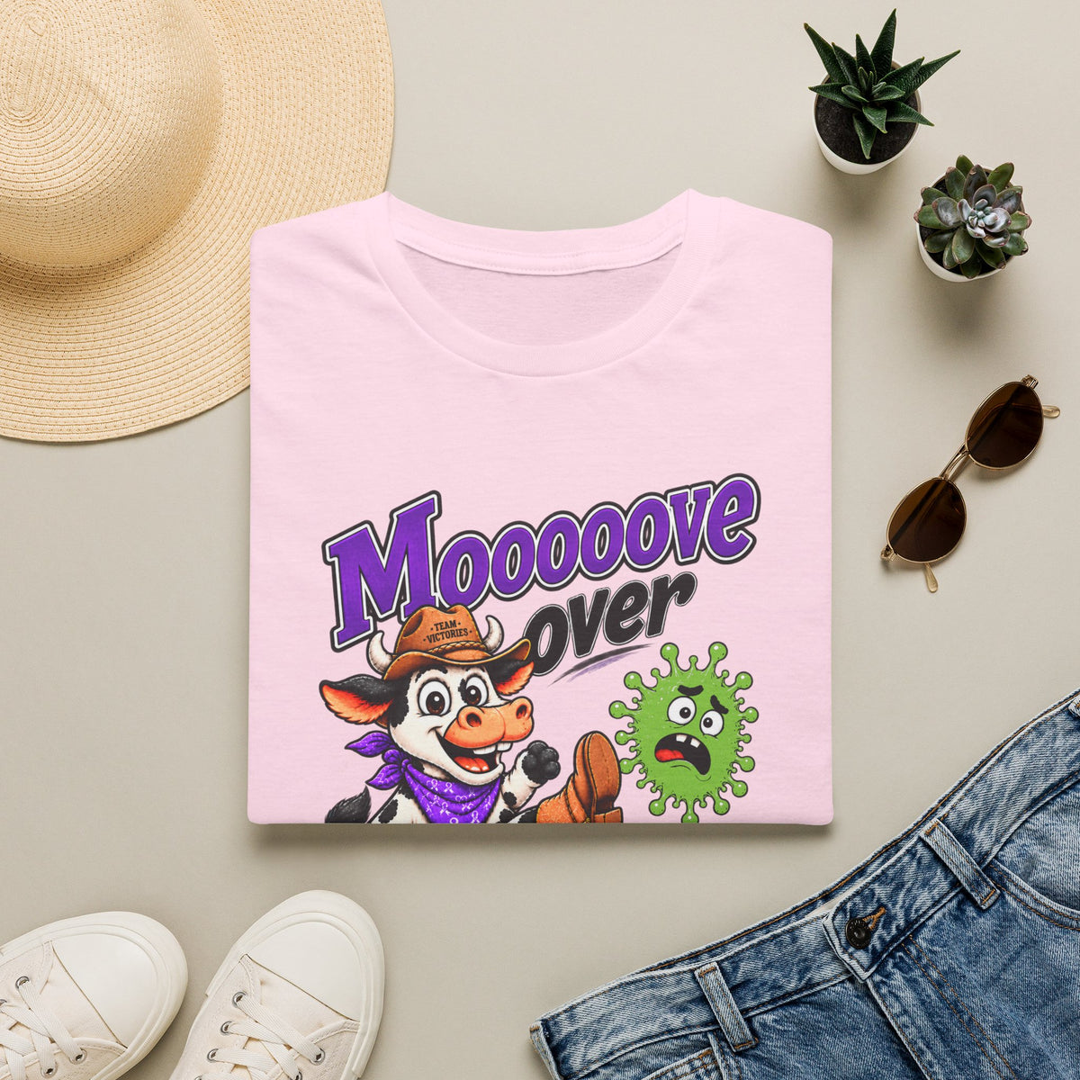 Folded pink Moooove Over Cancer shirt showing the front design