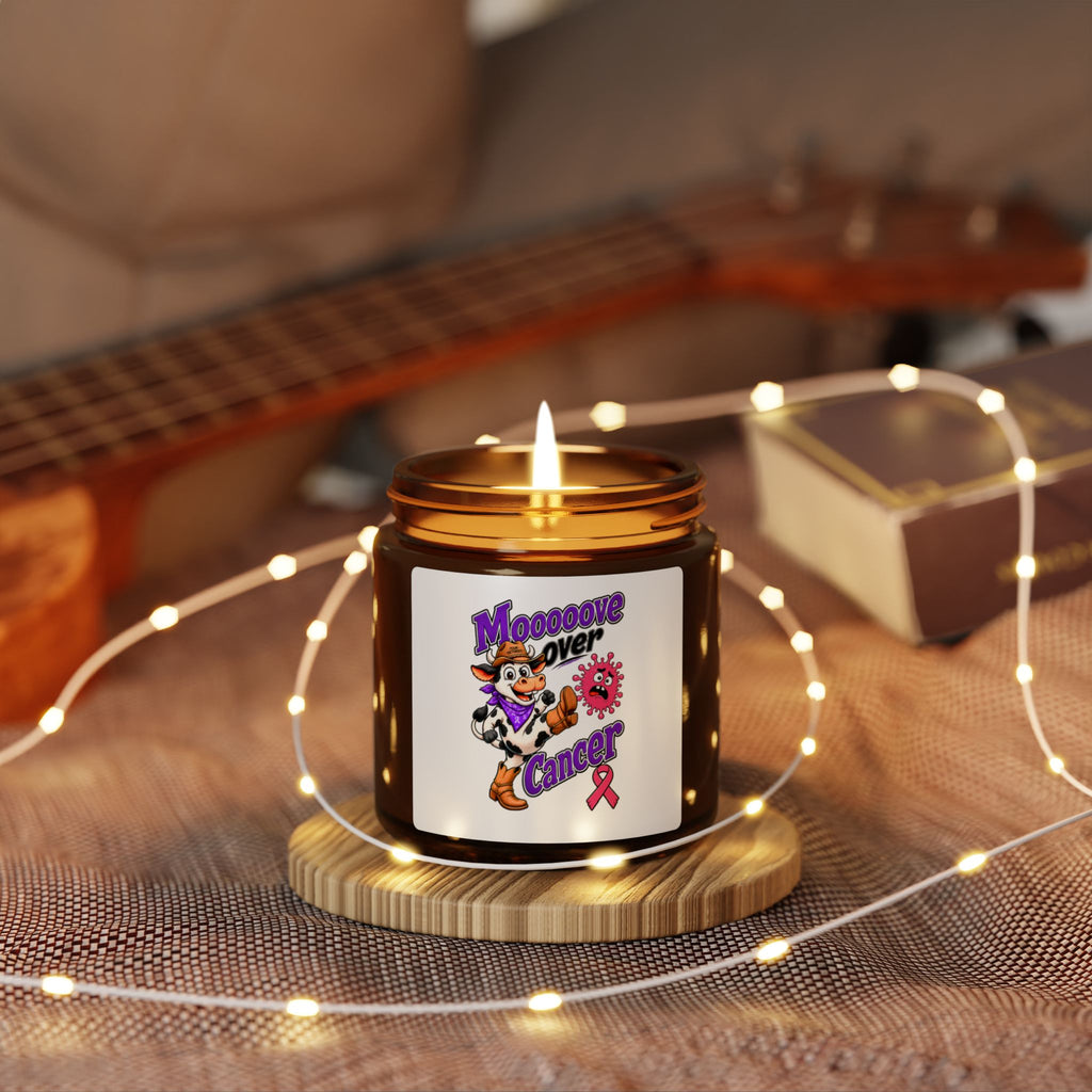 Moooove Over Cancer candle glowing in a cozy setting with a Breast Cancer awareness ribbon label