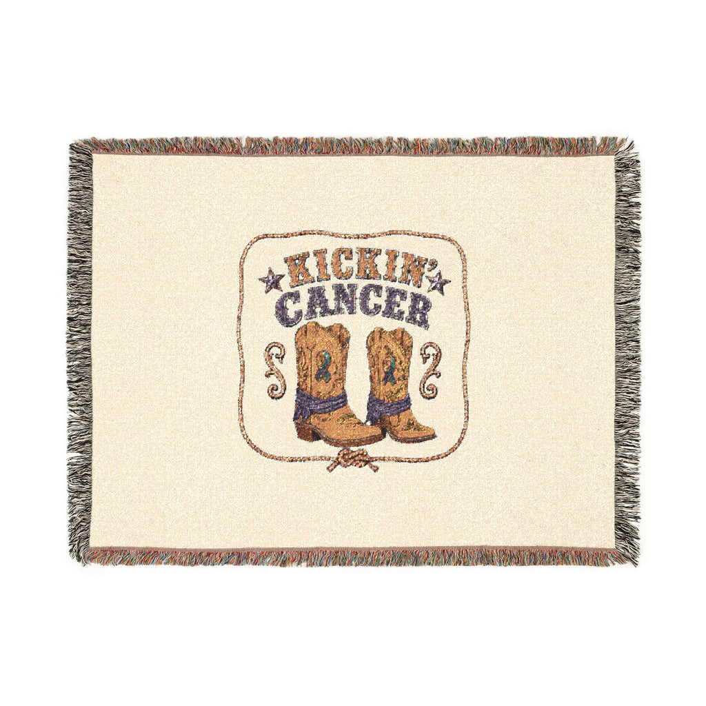Full view of the woven Kickin' Cancer blanket with cowboy boot artwork and decorative fringed edges