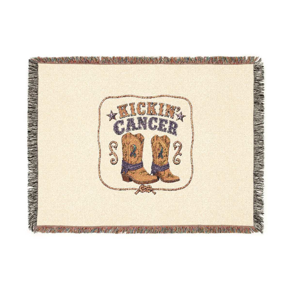 Full view of the woven Kickin' Cancer blanket with cowboy boot artwork and decorative fringed edges
