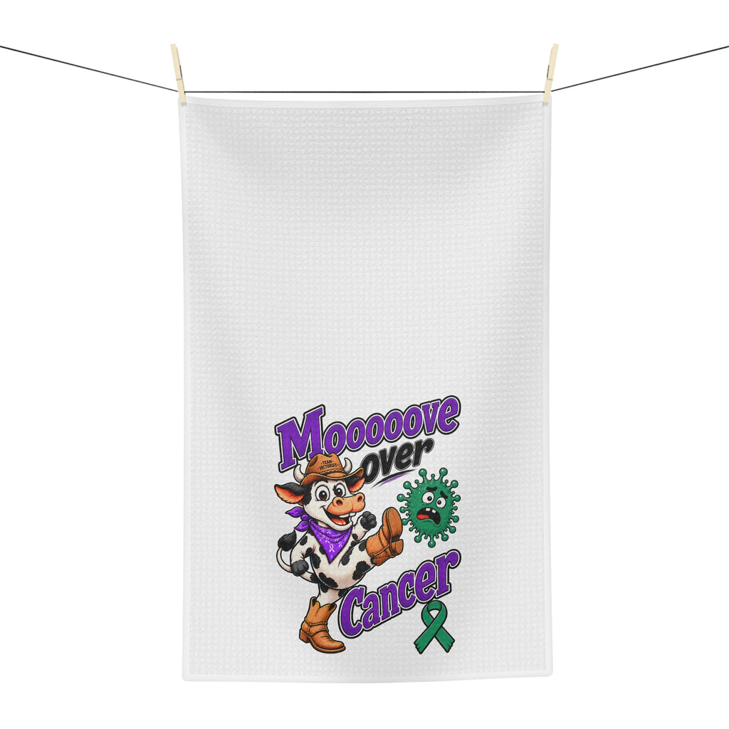Moooove Over Cancer tea towel hanging outdoors with cow character and green ribbon design
