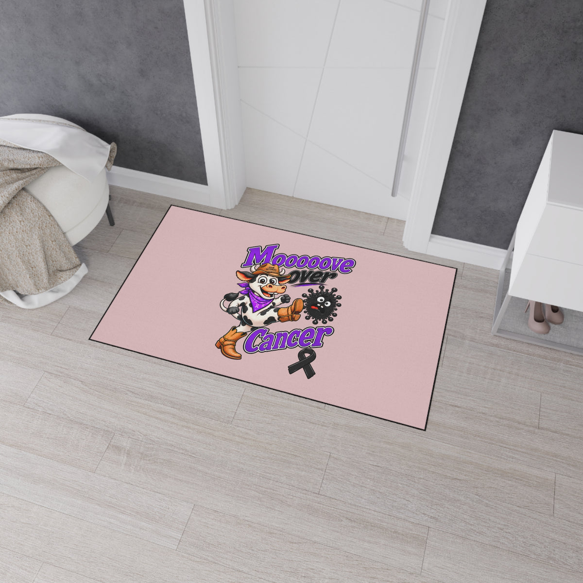 Moooove Over Cancer mat in a bedroom with a playful cow graphic