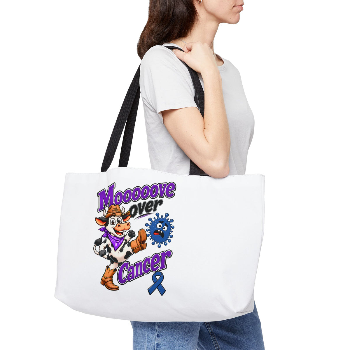 Moooove Over Cancer weekender tote worn over the shoulder with colorful cow design