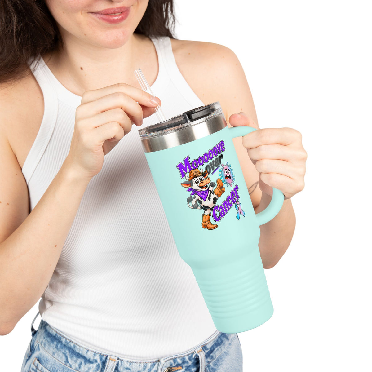 Person holding an aqua Moooove Over Cancer travel mug with straw and ergonomic handle