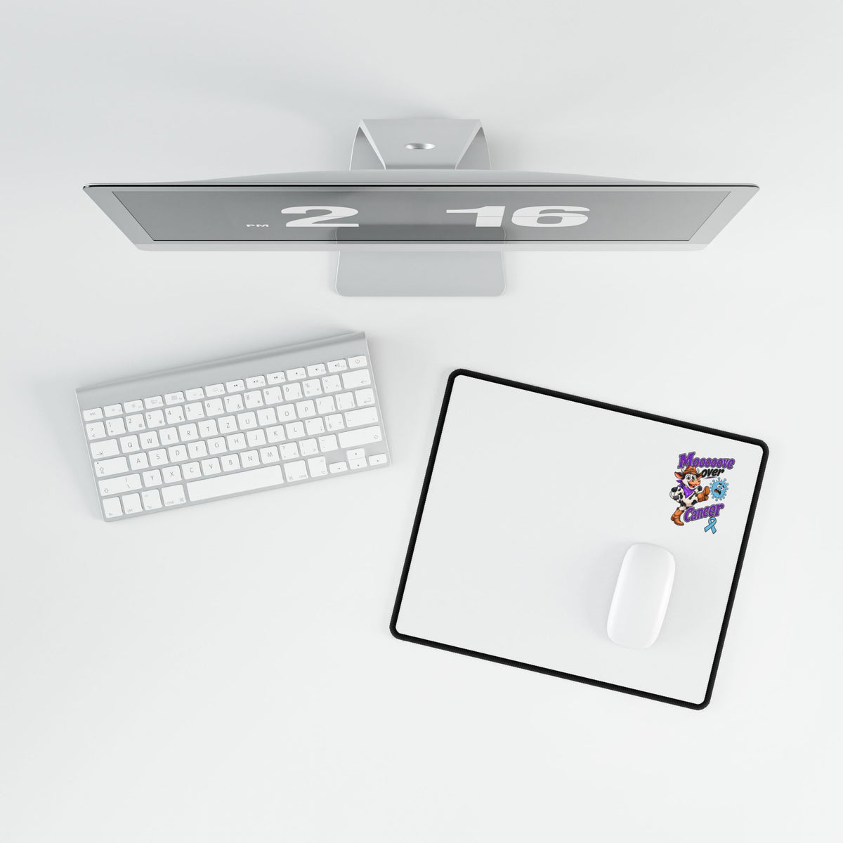Moooove Over Cancer desk mat in a desktop setup with a computer mouse