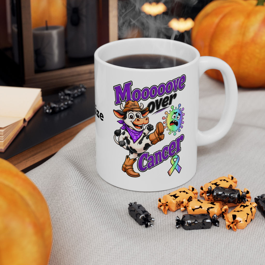 Moooove Over Cancer mug with an all-cancer awareness ribbon beside Halloween decor
