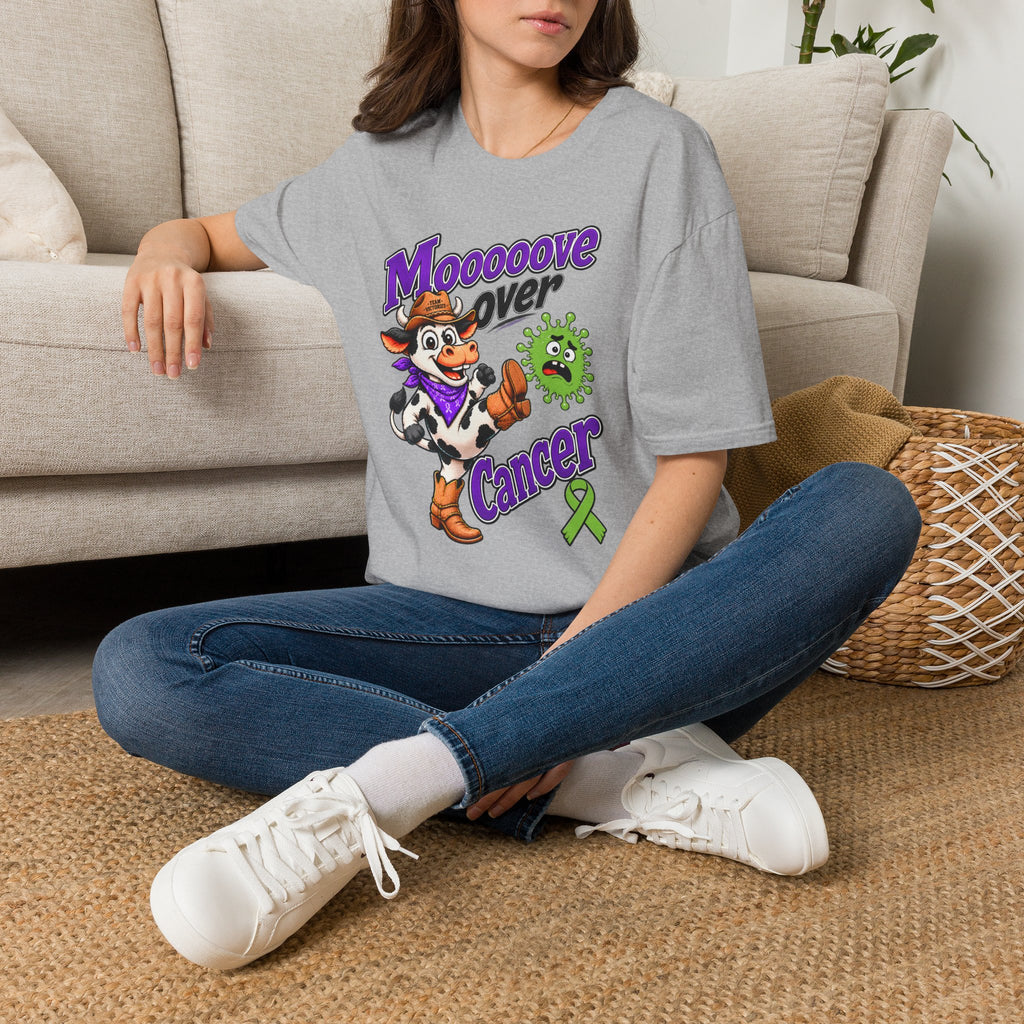 Woman seated wearing gray Moooove Over Cancer T-shirt