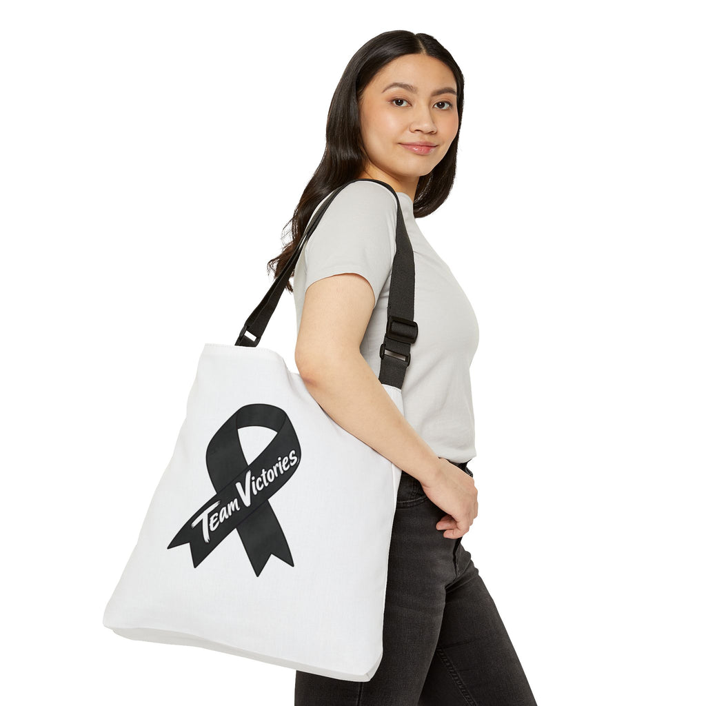 Moooove Over Cancer tote worn over the shoulder with cow artwork and awareness ribbon