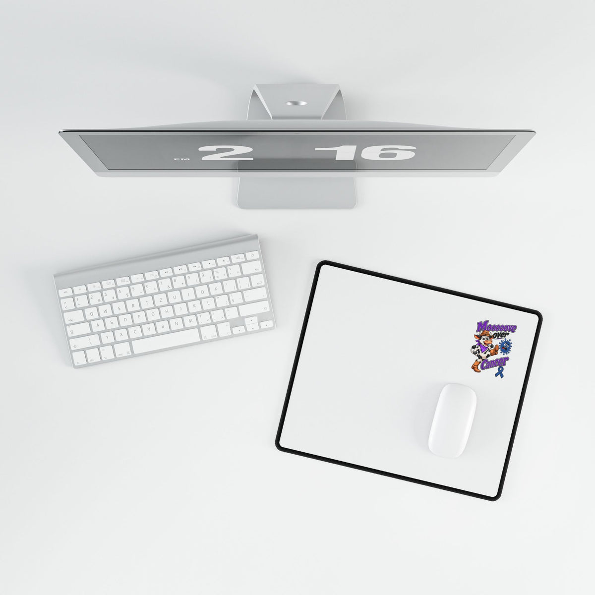 Moooove Over Cancer desk mat beside a keyboard and mouse, Colon Cancer awareness ribbon artwork