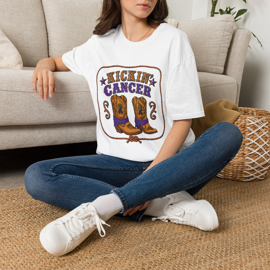 Model wearing the white Kickin' Cancer T-shirt with illustrated cowboy boots