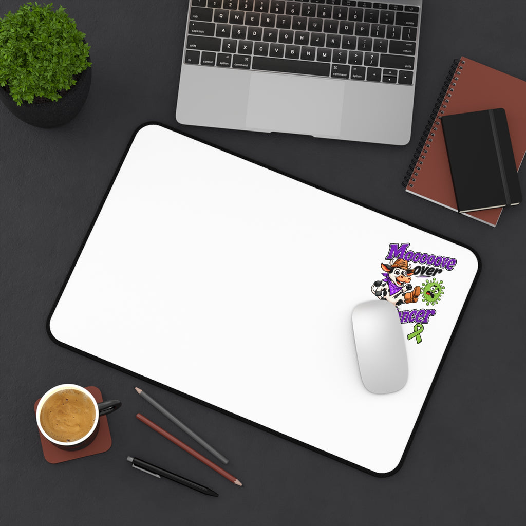 Moooove Over Cancer desk mat in a desktop setup with cow artwork and awareness design