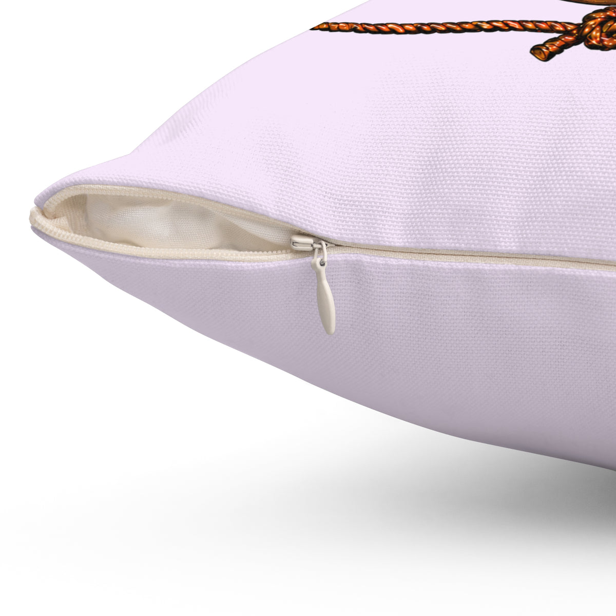 Close-up of the concealed beige zipper and metal pull on a lavender Kickin' Cancer pillow cover