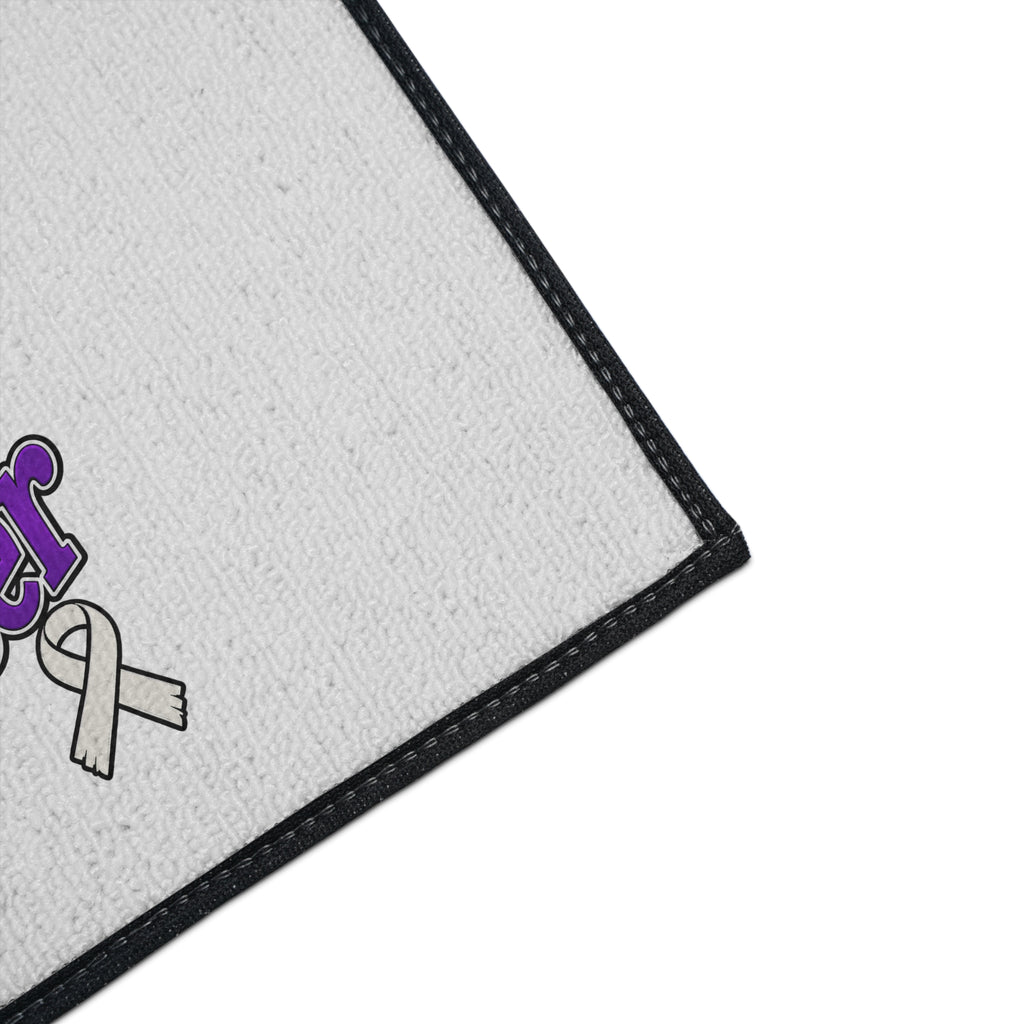 Close-up of Moooove Over Cancer artwork and Lung Cancer awareness ribbon on the mat