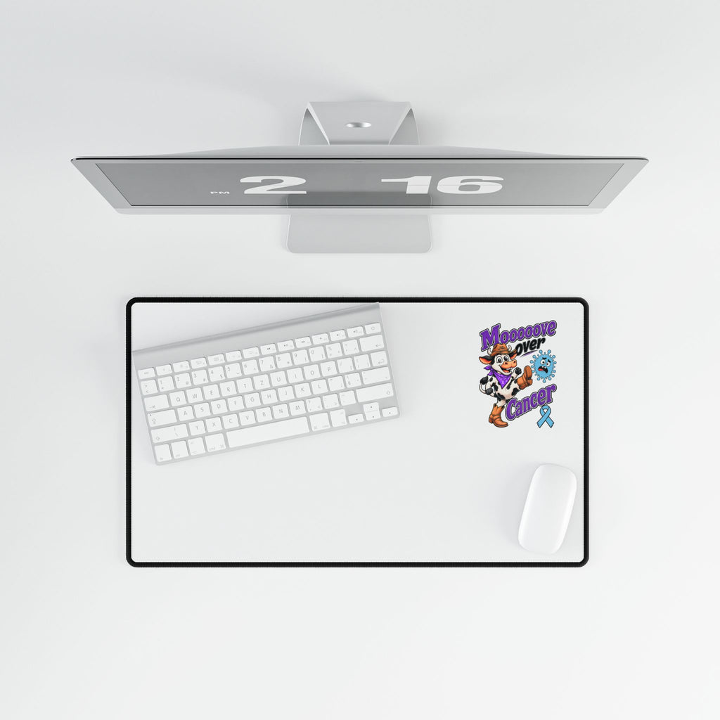 Moooove Over Cancer desk mat in a desktop workspace with keyboard and mouse