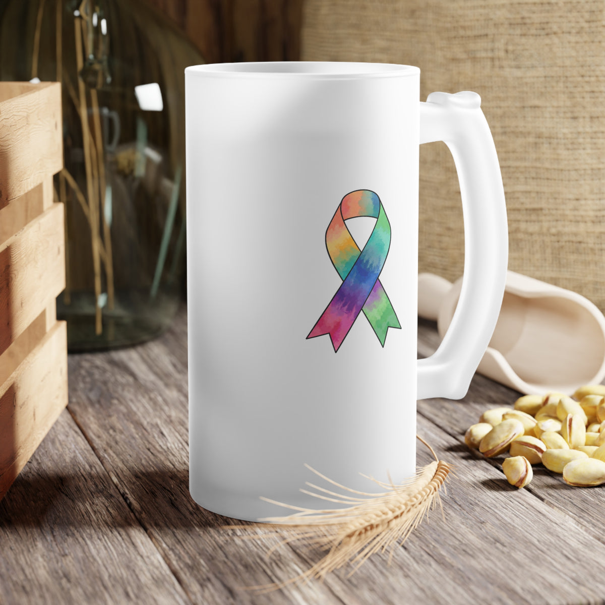 Frosted glass mug with a colorful ribbon displayed on a rustic table