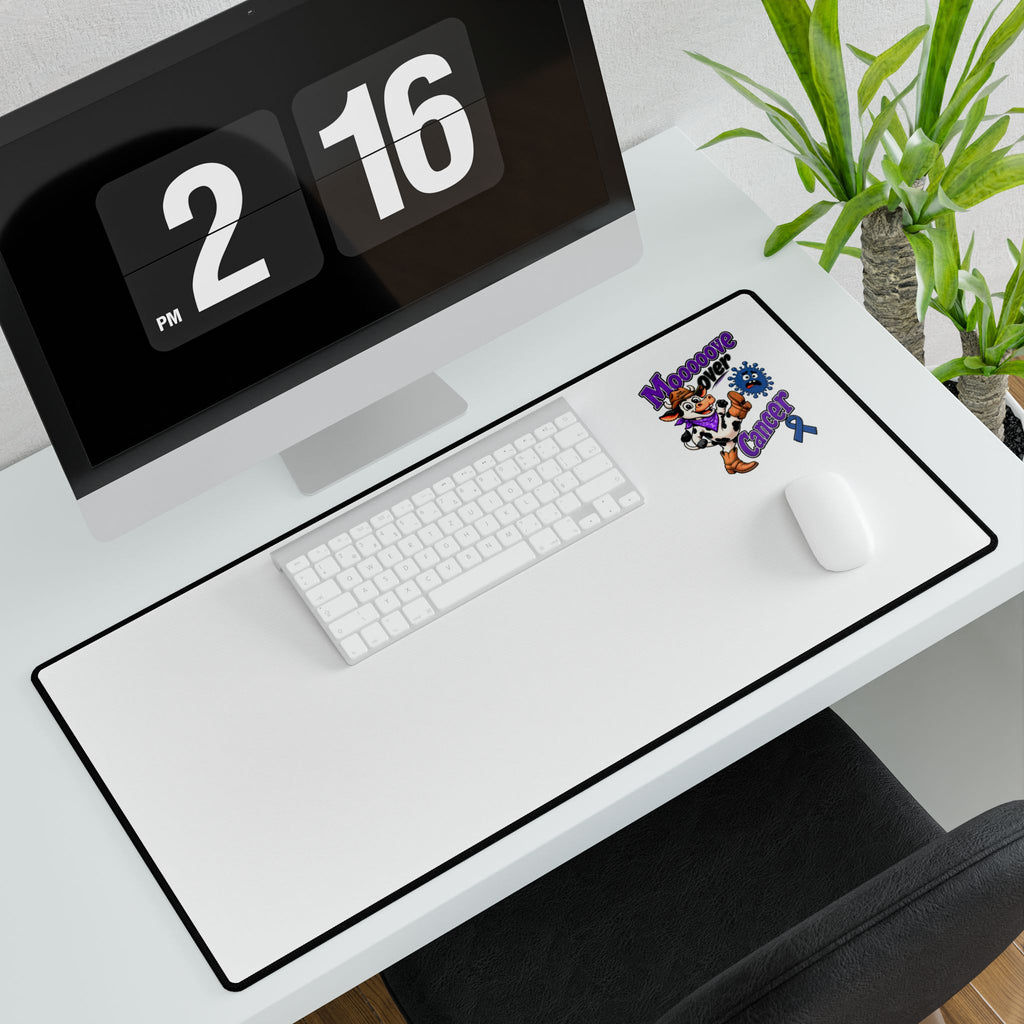 Moooove Over Cancer desk mat on a workstation with keyboard and mouse, Colon Cancer awareness ribbon
