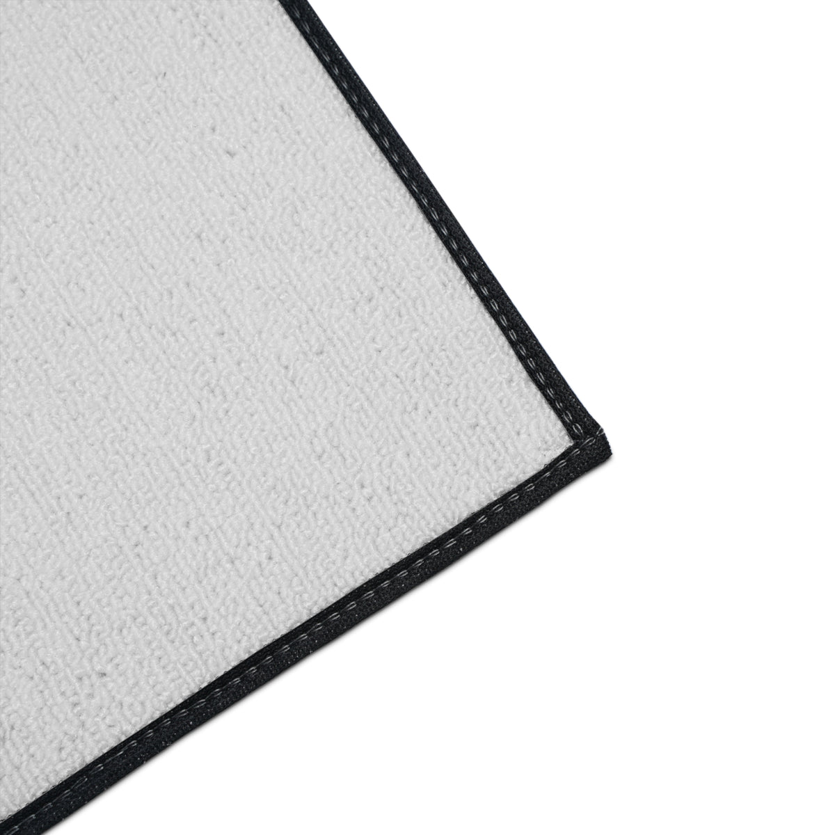 Close-up of the Moooove Over Cancer mat's white polyester surface and black edge