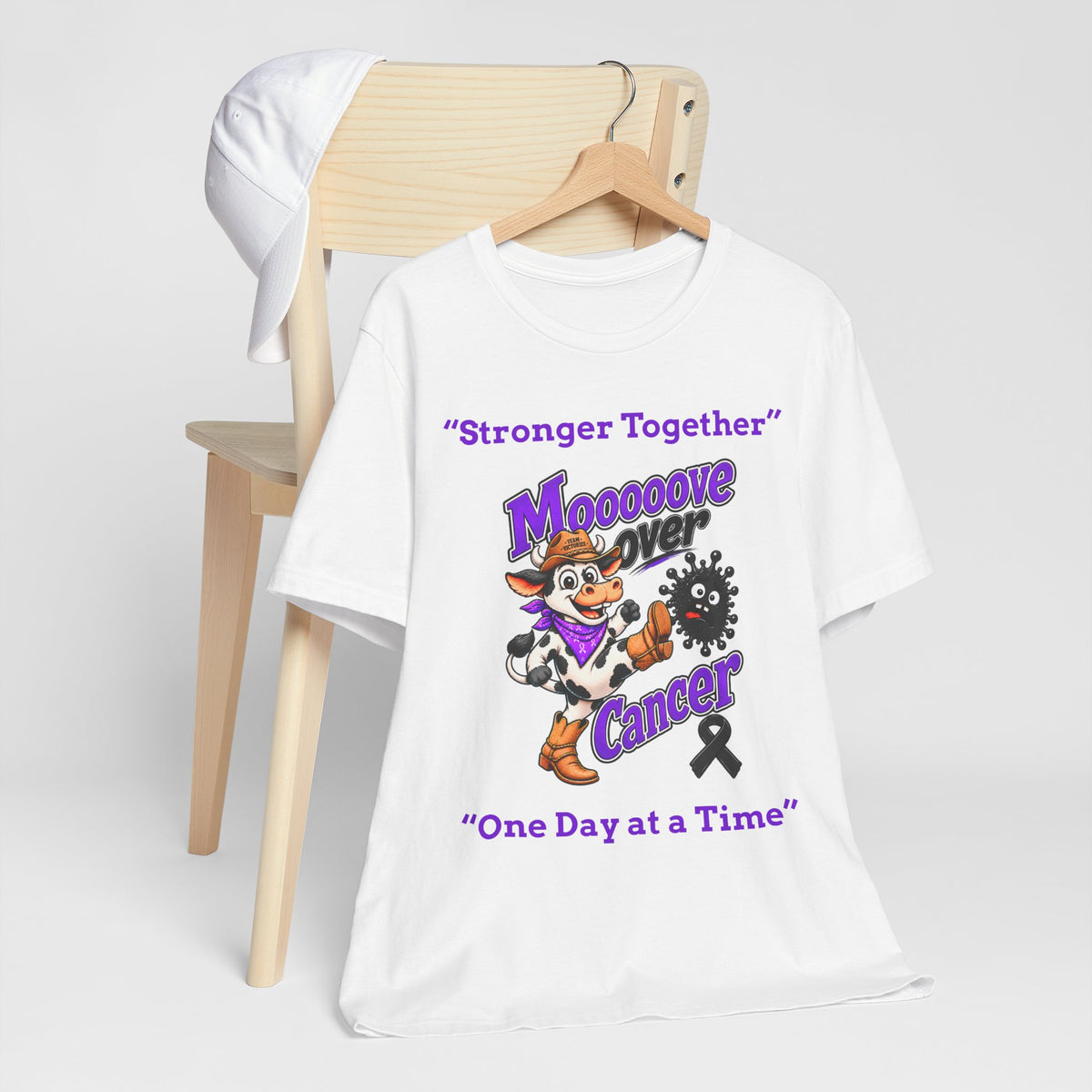 White Moooove Over Cancer T-shirt displayed on a clothing rack with full front design