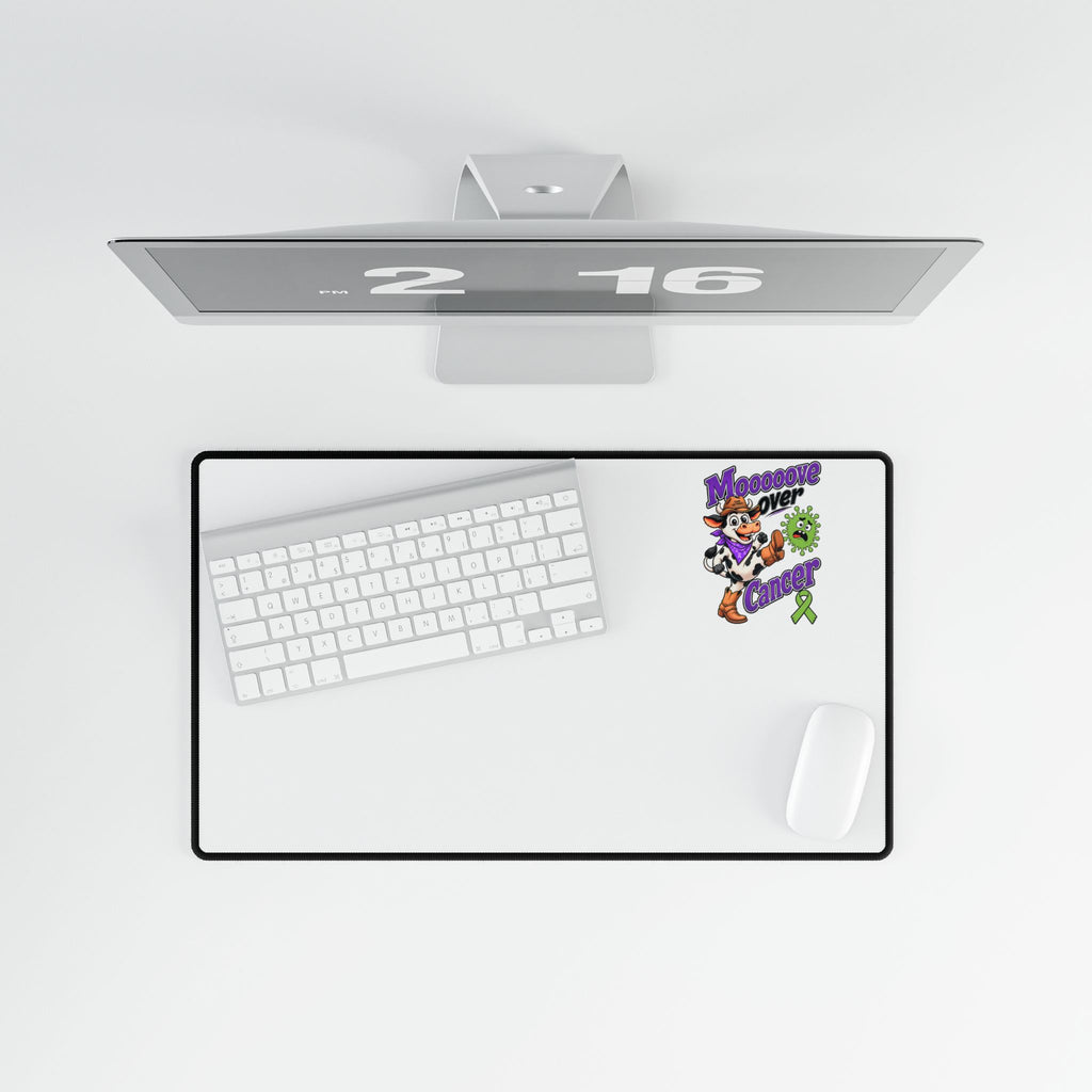 Moooove Over Cancer desk mat with green ribbon artwork beneath keyboard and mouse