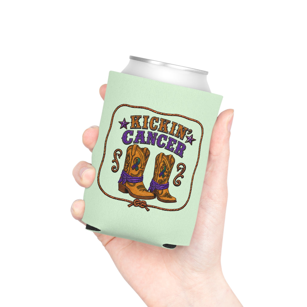 Hand holding a Kickin’ Cancer light green can cooler with western boot and awareness-ribbon artwork.