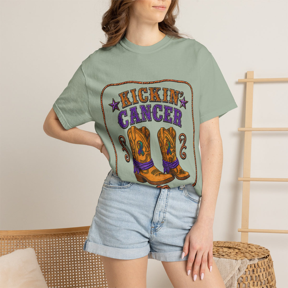 Woman wearing a green Kickin' Cancer T-shirt with cowboy boot front artwork