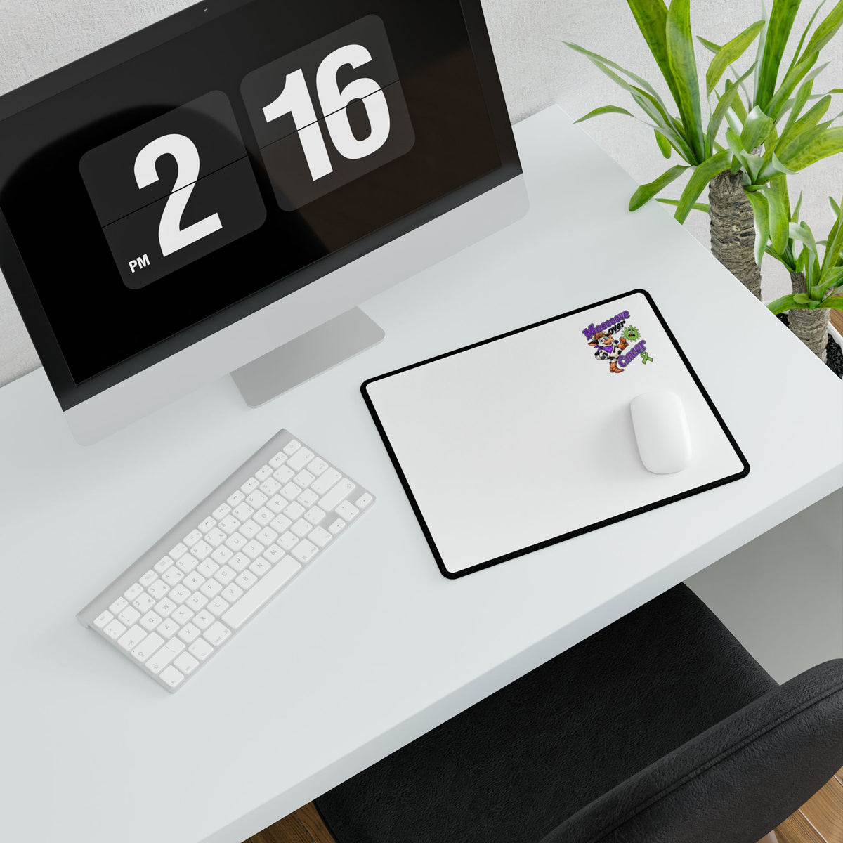 Moooove Over Cancer mouse pad beside a monitor with a white mouse