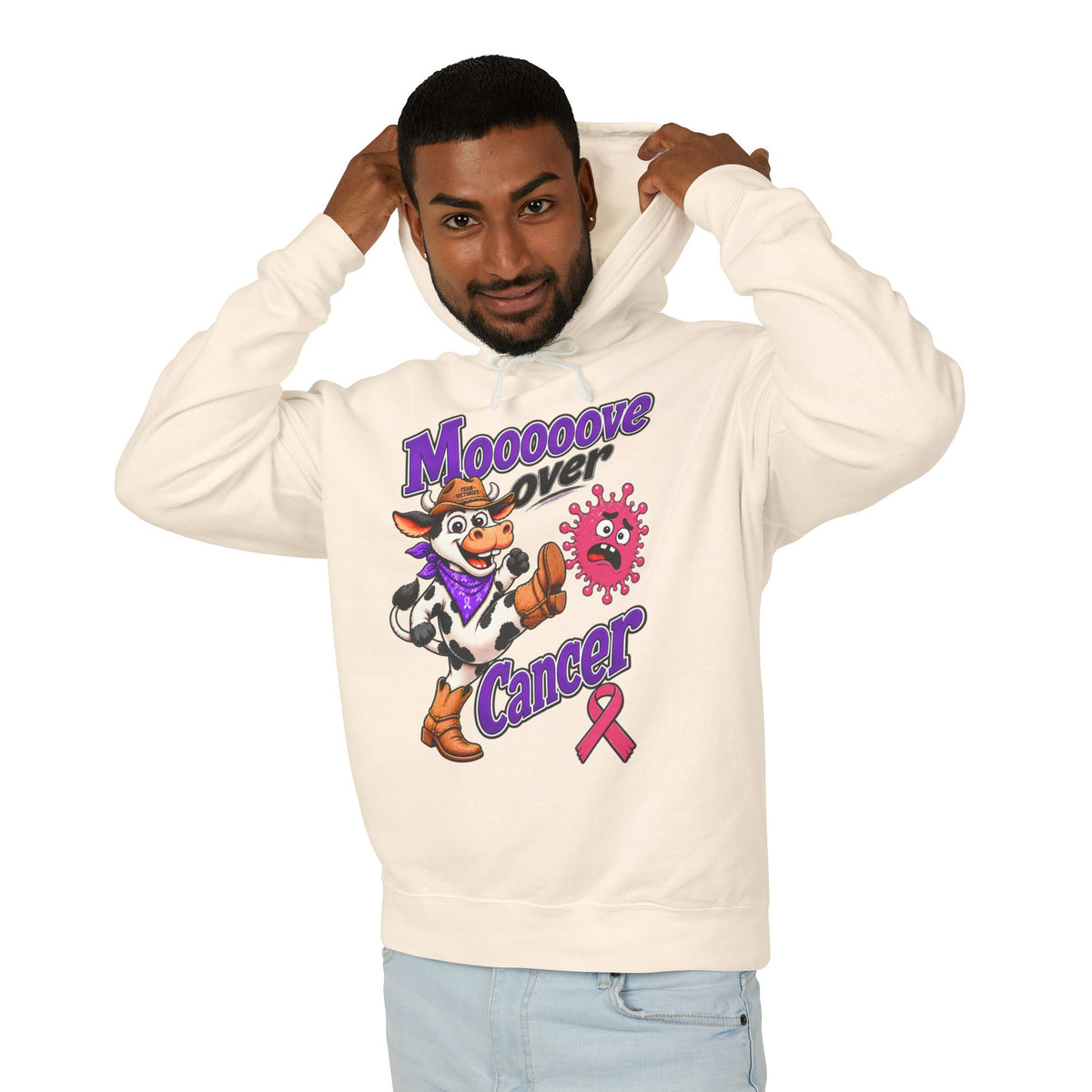 Man wearing a cream Moooove Over Cancer hoodie with Breast Cancer awareness ribbon artwork