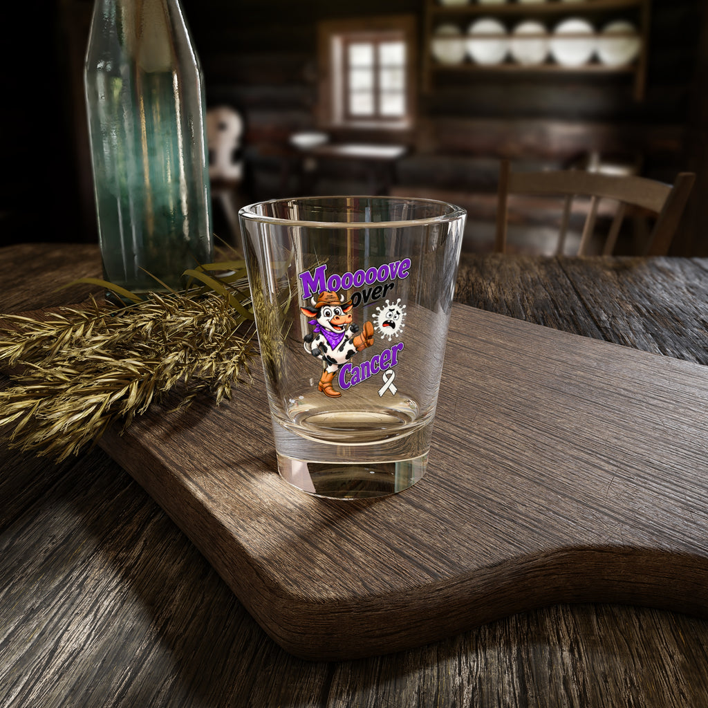 Moooove Over Cancer shot glass with cow artwork on a rustic wood table