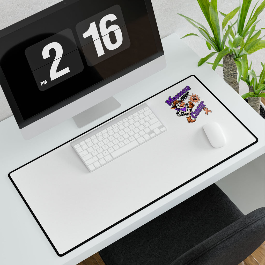 Moooove Over Cancer desk mat with keyboard and mouse on a computer desk