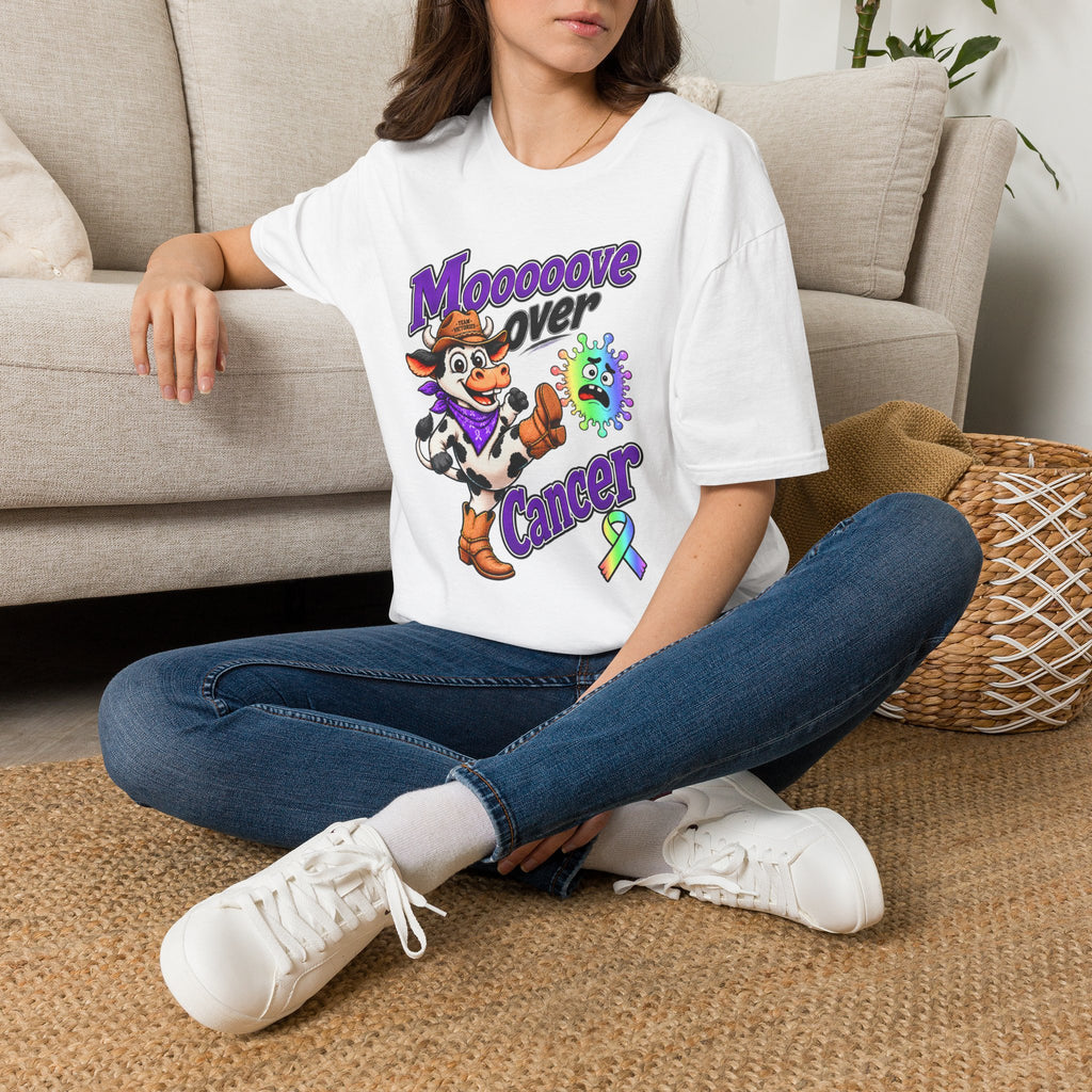 Woman wearing the white Moooove Over Cancer T-shirt while seated indoors