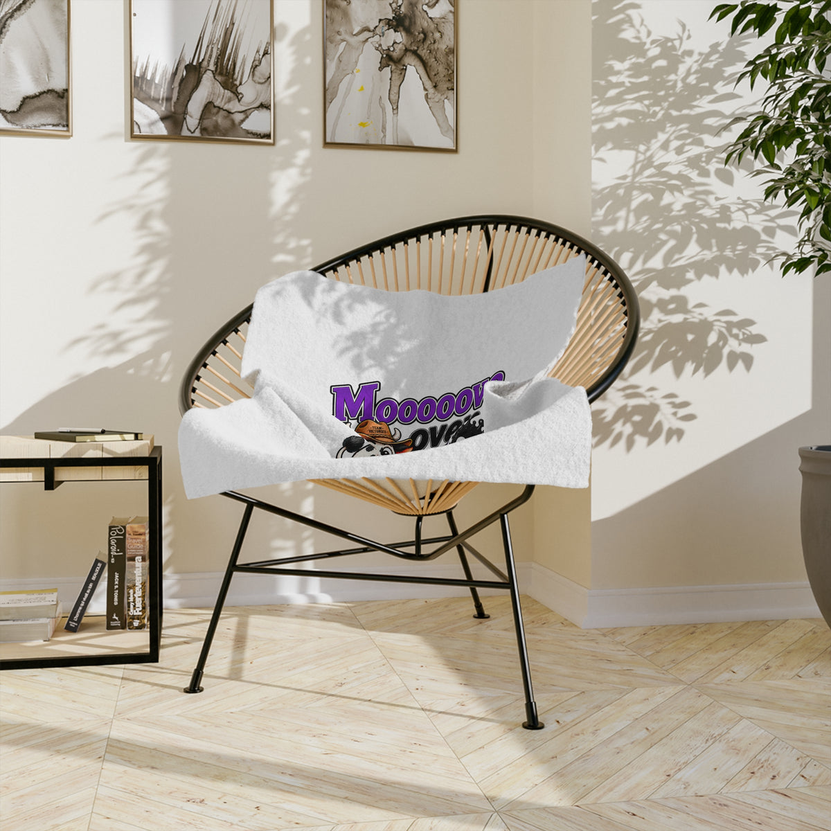 Moooove Over Cancer blanket draped over a modern chair