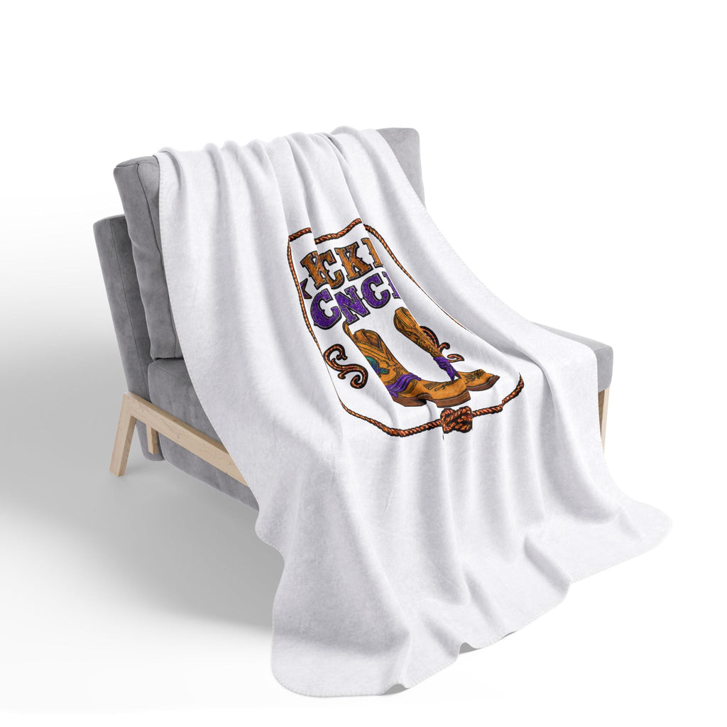 Kickin' Cancer sherpa blanket draped over a lounge chair
