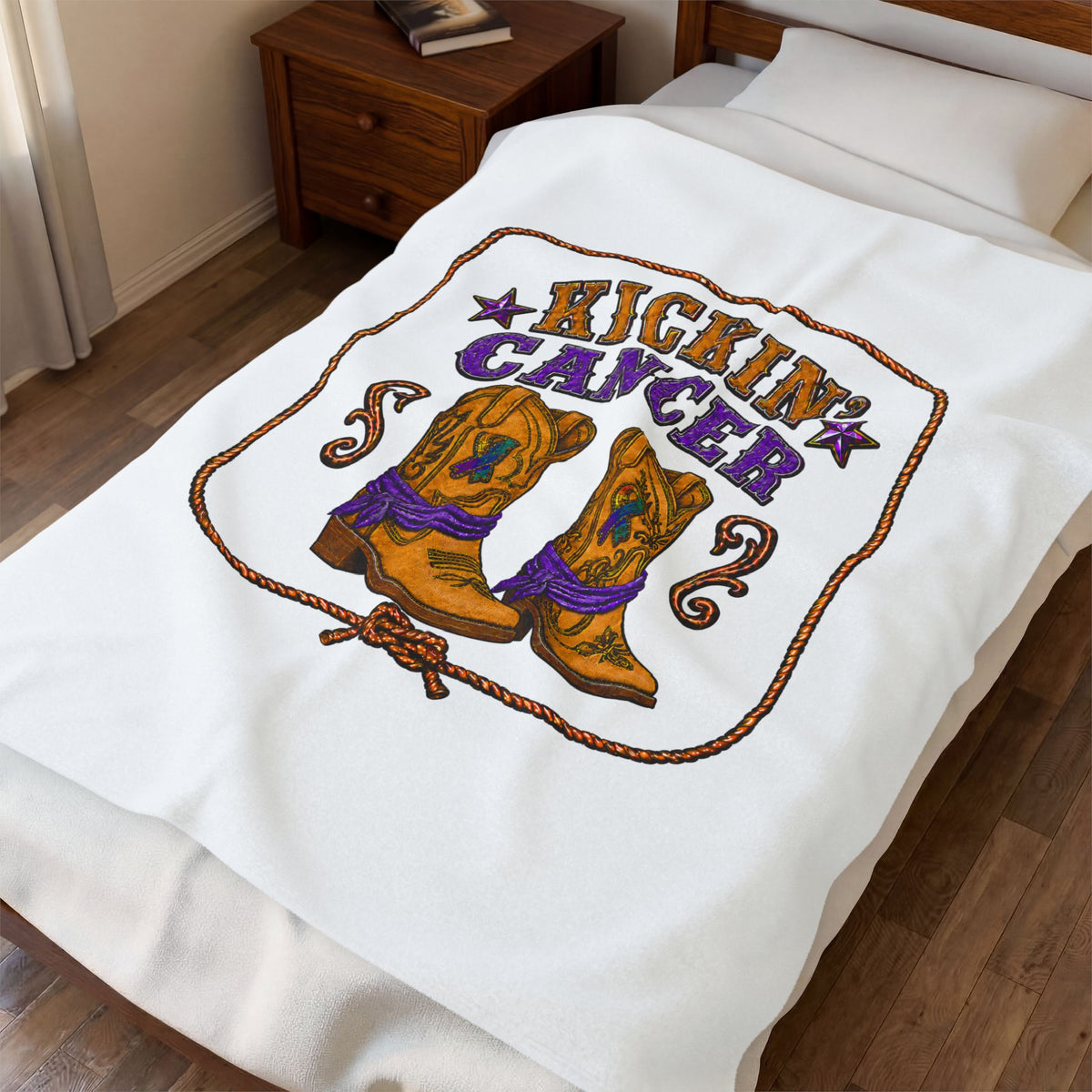 White Kickin' Cancer plush blanket spread on a bed with vertical cowboy boot artwork