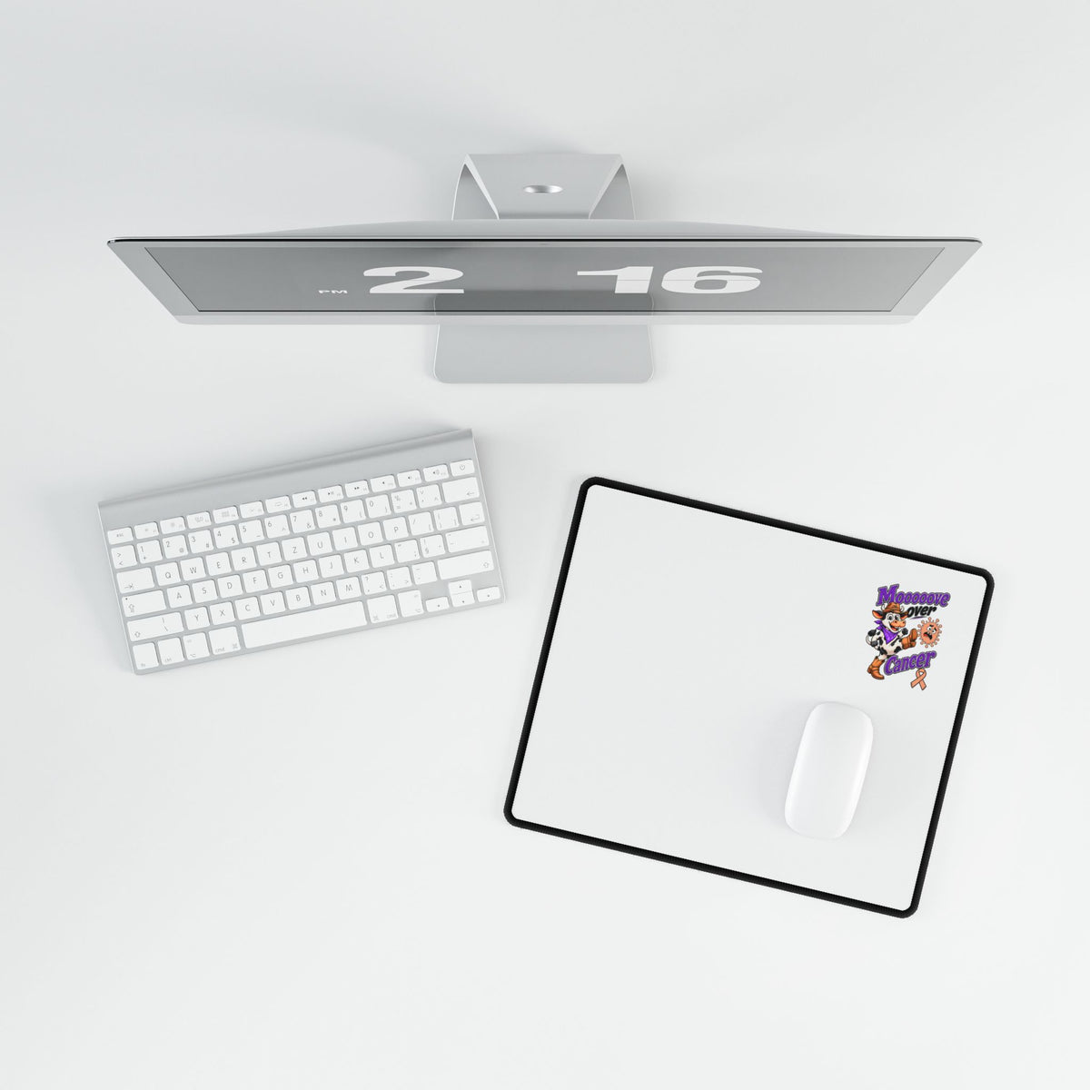 Moooove Over Cancer desk mat viewed from above with a keyboard and white mouse