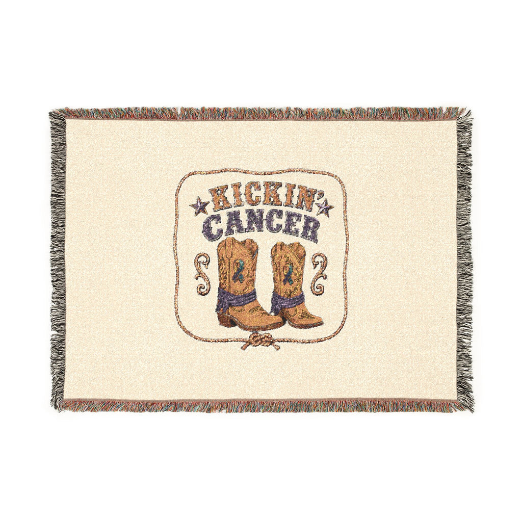 Flat view of the Kickin' Cancer woven blanket showing cowboy boots, message, and fringed edges