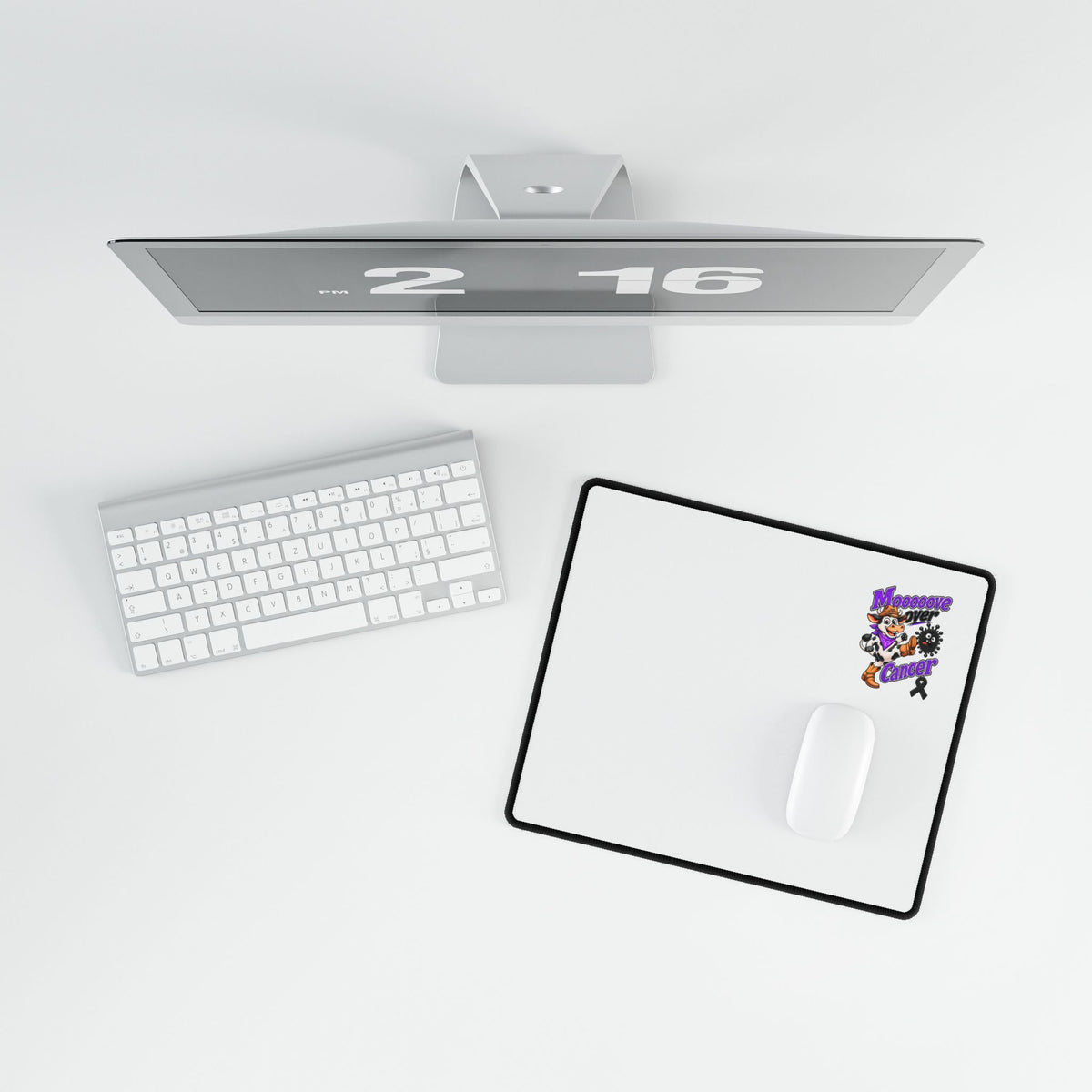 Moooove Over Cancer desk mat shown with a white mouse in a workspace setting