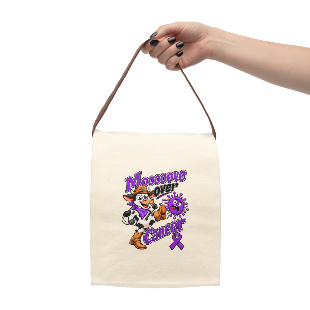Moooove Over Cancer lunch bag held by its strap, showing the cow and purple ribbon design